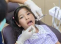 A dentist observing a girl